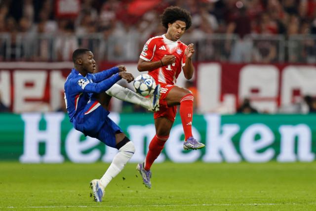 Bayern Munich's German forward #07 Serge Gnabry (R) and Chelsea's Ecuadorian midfielder #25 Moises Caicedo vie for the ball during the UEFA Champions League football match between FC Bayern Munich and Chelsea FC in Munich, southern Germany on September 17, 2025. (Photo by Alexandra BEIER / AFP)