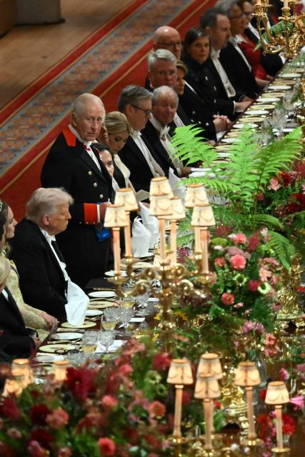 Britain's King Charles III (L) stands beside US President Donald Trump to deliver a speech at a State Banquet at Windsor Castle, in Windsor, on September 17, 2025, during the second State Visit of US President Donald Trump. US President Donald Trump arrived in Britain for an unprecedented second State Visit, with the UK government rolling out a royal red carpet welcome to win over the mercurial leader. (Photo by ANDREW CABALLERO-REYNOLDS / POOL / AFP)