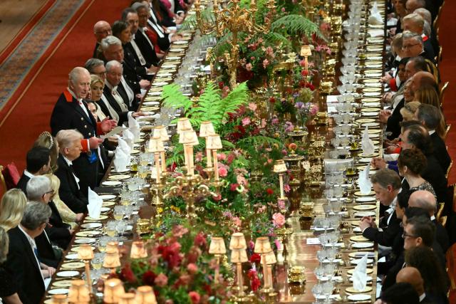 Britain's King Charles III (centre left) stands beside US President Donald Trump to deliver a speech at a State Banquet at Windsor Castle, in Windsor, on September 17, 2025, during the second State Visit of US President Donald Trump. US President Donald Trump arrived in Britain for an unprecedented second State Visit, with the UK government rolling out a royal red carpet welcome to win over the mercurial leader. (Photo by ANDREW CABALLERO-REYNOLDS / POOL / AFP)