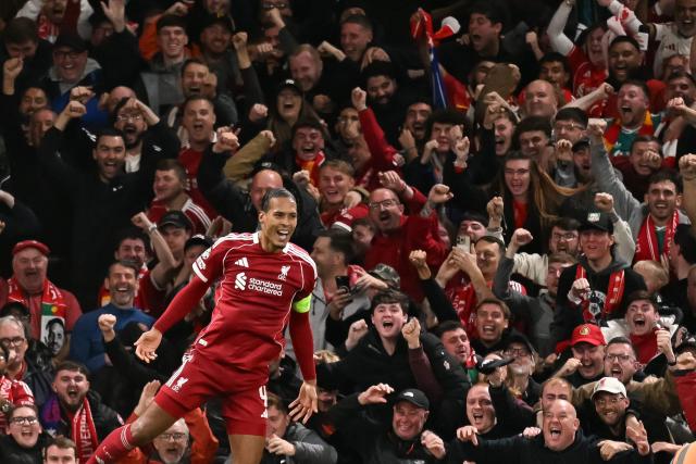 Liverpool's Dutch defender #04 Virgil van Dijk celebrates scoring his team's third goal during the UEFA Champions League first round football match between Liverpool and Atletico Madrid at Anfield in Liverpool, north west England on September 17, 2025. (Photo by Oli SCARFF / AFP)