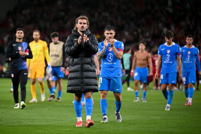 Atletico Madrid's French forward #07 Antoine Griezmann (C-L) and teammate Spanish defender #21 Javi Galan applause to their supporters at the end of the UEFA Champions League first round football match between Liverpool and Atletico Madrid at Anfield in Liverpool, north west England on September 17, 2025. (Photo by Oli SCARFF / AFP)