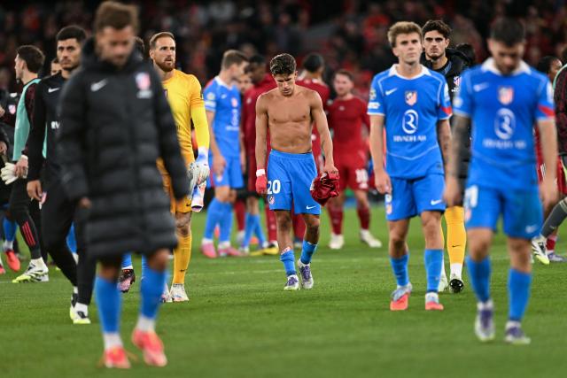 Atletico Madrid's players with Argentine forward #20 Giuliano Simeone French looks dejected at the end of the UEFA Champions League first round football match between Liverpool and Atletico Madrid at Anfield in Liverpool, north west England on September 17, 2025. (Photo by Oli SCARFF / AFP)