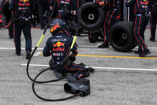 Red Bull Racing' mechanics wait in the pit lane during the Formula One Dutch Grand Prix at The Circuit Zandvoort, western Netherlands, on August 31, 2025. (Photo by Patrick Post / POOL / AFP)