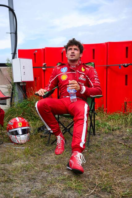 Ferrari's Monegasque driver Charles Leclerc reacts outside the track after crashing during the Formula One Dutch Grand Prix at The Circuit Zandvoort, western Netherlands, on August 31, 2025. (Photo by JOHN THYS / AFP)