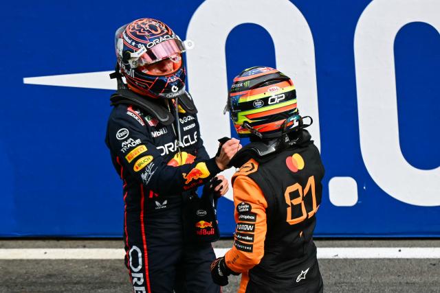 McLaren's Australian driver Oscar Piastri (R) is congratulated by second-placed Red Bull Racing's Dutch driver Max Verstappen after winning the Formula One Dutch Grand Prix at The Circuit Zandvoort, western Netherlands, on August 31, 2025. (Photo by NICOLAS TUCAT / AFP)
