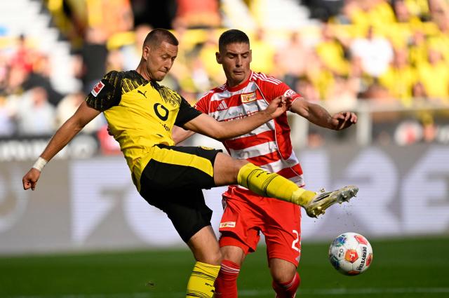 Dortmund's German defender #03 Waldemar Anton (L) and Union Berlin's Serbian forward #23 Andrej Ilic vie for the ball during the German first division Bundesliga football match between Borussia Dortmund and Union Berlin in Dortmund, Germany on August 31, 2025. (Photo by INA FASSBENDER / AFP) / DFL REGULATIONS PROHIBIT ANY USE OF PHOTOGRAPHS AS IMAGE SEQUENCES AND/OR QUASI-VIDEO