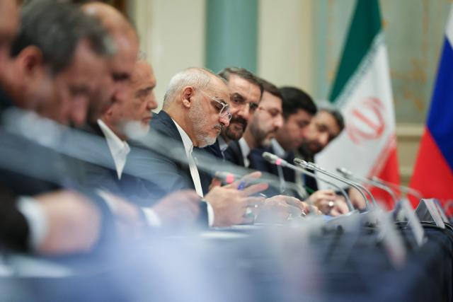 In this pool photograph distributed by the Russian state agency Sputnik, Irianian president's chief of staff Mohsen Haji-Mirzaei (C) attends a meeeting between Iran's and Russia's presidents on the sidelines of the Shanghai Cooperation Organisation (SCO) Summit in Tianjin on September 1, 2025. (Photo by Alexander KAZAKOV / POOL / AFP)