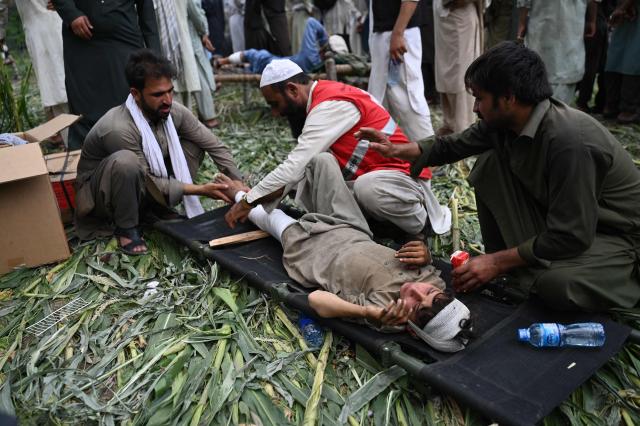 TOPSHOT - An Afghan injured boy lays on a stretcher as he receives treatment at a field near damaged houses in the Mazar Dara village of Nurgal, a district of the Kunar Province, in Eastern Afghanistan, on September 1, 2025. More than 800 people have died and over 2,700 were injured from August 31 night to September 1, 2025, in eastern Afghanistan after a 6-magnitude earthquake, followed by at least five aftershocks felt hundreds of kilometers away. (Photo by Wakil Kohsar / AFP)