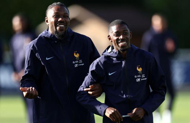 France's forward #15 Marcus Thuram (L) jokes with France's forward #11 Ousmane Dembele after a training session during preparations for the upcoming FIFA World Cup 2026 Group D European qualification football matches, at the team's training center in Clairefontaine-en-Yvelines, southwest of Paris, on September 1, 2025. France will face Ukraine on September 5 and Iceland on September 9, 2025. (Photo by FRANCK FIFE / AFP)