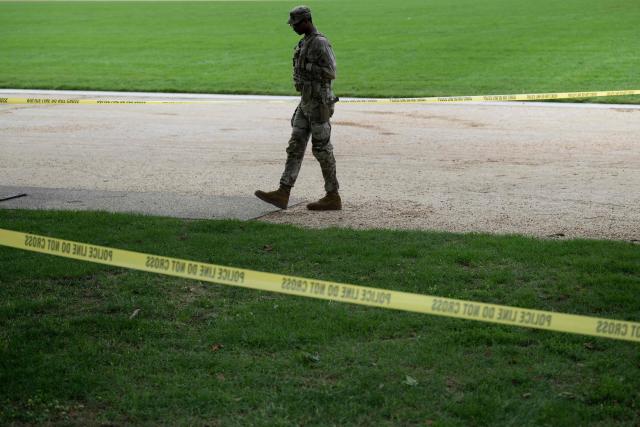 A member of the National Guard stands behind police tape at the scene of an industrial accident on the National Mall on September 17, 2025, in Washington, DC. US President Donald Trump on September 15 signed an order sending National Guard troops to the city of Memphis, in the latest stage of his crime crackdown that critics have branded authoritarian. Trump said the task force would be a "replica" of the one he sent into the capital Washington in August. (Photo by Brendan Smialowski / AFP)