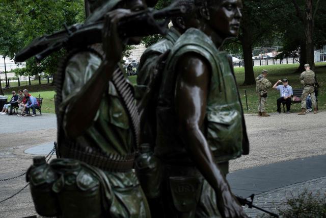 Members of the National Guard speak with a man as they patrol the National Mall on September 17, 2025, in Washington, DC. US President Donald Trump on September 15 signed an order sending National Guard troops to the city of Memphis, in the latest stage of his crime crackdown that critics have branded authoritarian. Trump said the task force would be a "replica" of the one he sent into the capital Washington in August. (Photo by Brendan Smialowski / AFP)