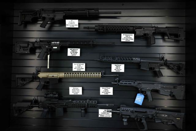 Semi-automatic rifles are displayed for sale in a gun store in Rio Rico, Santa Cruz County, Arizona on September 17, 2025. Arizona allows individuals legally eligible to own guns to carry them without a permit, background checks apply to dealer sales but not most private transactions. (Photo by CHARLY TRIBALLEAU / AFP)