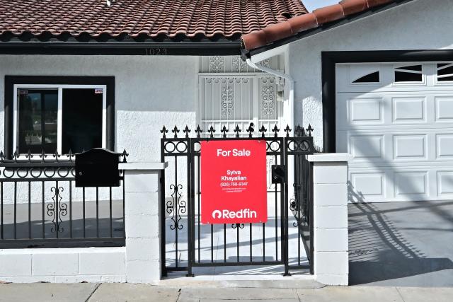 A 'for sale' sign is seen on a house in Monterey Park, California, on September 17, 2025. The US Federal Reserve on September 17 lowered interest rates for the first time this year, flagging slower job gains and risks to employment as policymakers face heightened pressure under President Donald Trump. (Photo by Frederic J. BROWN / AFP)