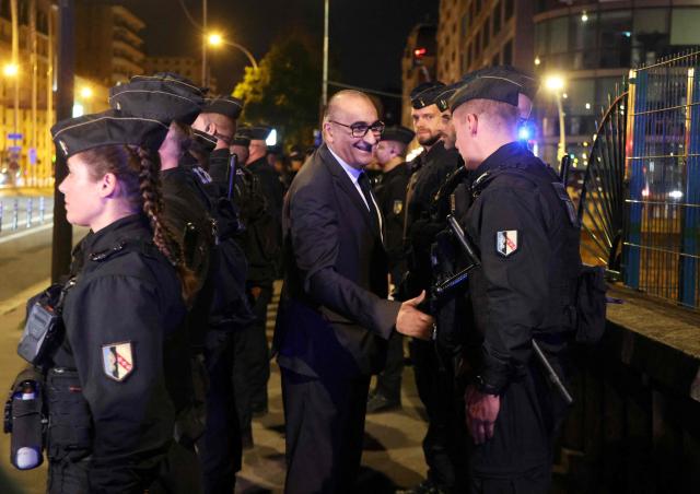 Paris Police Prefect Laurent Nunez (C) shakes hands with a policeman at Porte d'Orléans in Paris on September 18, 2025, prior to a day of nationwide strikes and protests called by unions over France's national budget. France is bracing for a day of nationwide protests on September 18, 2025, with a source close to the authorities saying some 800,000 people are expected to take to the streets. In a rare show of unity, trade unions have urged French people to strike in protest at the authorities' "horror show" draft budget designed to reduce France's ballooning debt. (Photo by Ludovic MARIN / AFP)