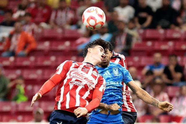 Guadalajara's forward #34 Armando Gonzalez and Tigres' defender #20 Javier Aquino fight for the ball during the Liga MX Apertura football tournament match between Guadalajara and Tigres at the Akron Stadium in Zapopan, Jalisco state, Mexico on September 17, 2025. (Photo by Ulises Ruiz / AFP)