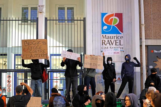 Students protest as they block the entrance to Maurice Ravel school in Paris, on September 18, 2025, during a day of nationwide strikes and protests called by unions over France's national budget. France is bracing for a day of nationwide protests on September 18, 2025, with a source close to the authorities saying some 800,000 people are expected to take to the streets. In a rare show of unity, trade unions have urged French people to strike in protest at the authorities' "horror show" draft budget designed to reduce France's ballooning debt. (Photo by GEOFFROY VAN DER HASSELT / AFP)