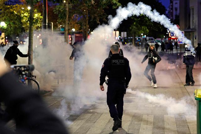 A tear gas canister is thrown as Police and demonstrators clash in Paris, on September 18, 2025, during a day of nationwide strikes and protests called by unions over France's national budget. France is bracing for a day of nationwide protests on September 18, 2025, with a source close to the authorities saying some 800,000 people are expected to take to the streets. In a rare show of unity, trade unions have urged French people to strike in protest at the authorities' "horror show" draft budget designed to reduce France's ballooning debt. (Photo by GEOFFROY VAN DER HASSELT / AFP)