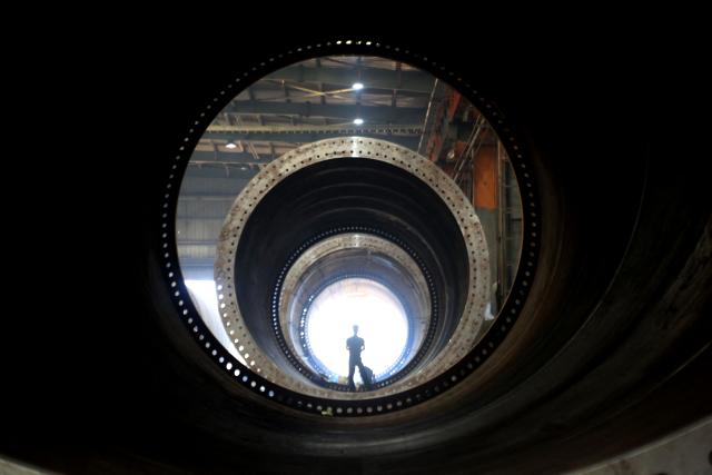 A worker makes part of wind turbines at a factory in Lianyungang, in China’s eastern Jiangsu province on September 18, 2025. (Photo by AFP) / China OUT
