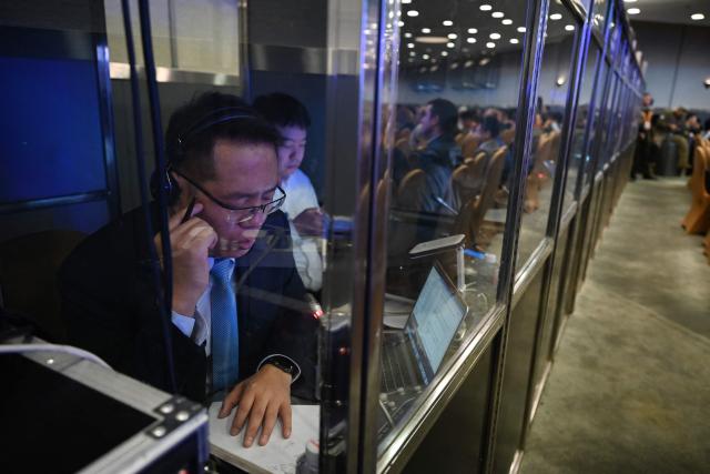A translator works during the plenary session of the Xiangshan Forum at the Beijing International Convention Center in Beijing on September 18, 2025. (Photo by GREG BAKER / AFP)