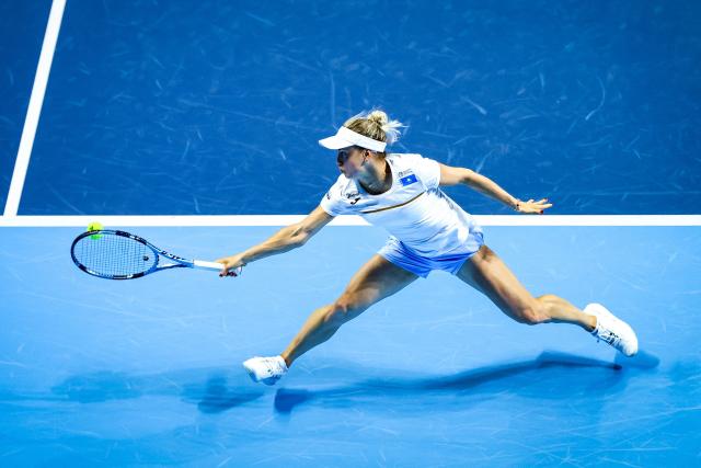 Kazakhstan's Yulia Putintseva hits a return against USA's Emma Navarro during their women’s singles tennis match at the Billie Jean King Cup quarter-finals in Shenzhen, China’s southern Guangdong province on September 18, 2025. (Photo by AFP) / China OUT