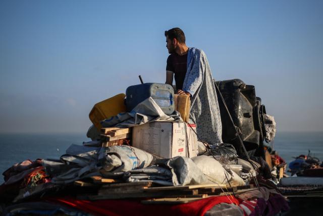 Displaced Palestinians move with their belongings southwards on a road in the Nuseirat refugee camp area in the central Gaza Strip following renewed Israeli evacuation orders for Gaza City on September 18, 2025. Israel has announced a major ground assault in Gaza City that it says is aimed at crushing Hamas in the Palestinian territory's largest urban hub. (Photo by Eyad BABA / AFP)