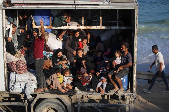 Displaced Palestinians move with their belongings southwards on a road in the Nuseirat refugee camp area in the central Gaza Strip following renewed Israeli evacuation orders for Gaza City on September 18, 2025. Israel has announced a major ground assault in Gaza City that it says is aimed at crushing Hamas in the Palestinian territory's largest urban hub. (Photo by Eyad BABA / AFP)