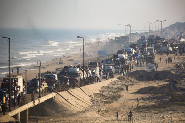 Displaced Palestinians move with their belongings southwards on a road in the Nuseirat refugee camp area in the central Gaza Strip following renewed Israeli evacuation orders for Gaza City on September 18, 2025. Israel has announced a major ground assault in Gaza City that it says is aimed at crushing Hamas in the Palestinian territory's largest urban hub. (Photo by Eyad BABA / AFP)
