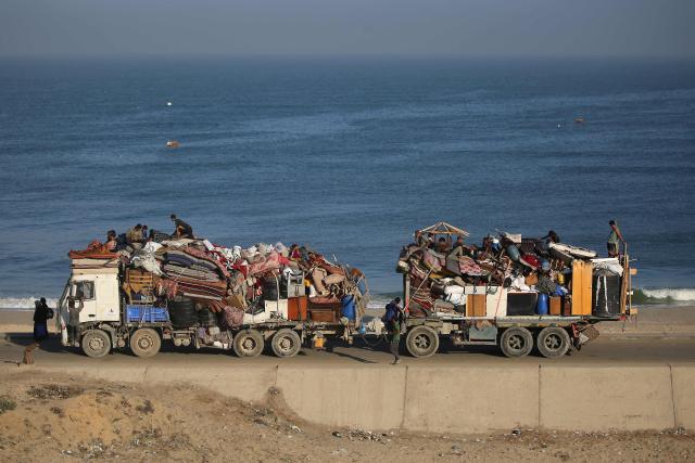 Displaced Palestinians move with their belongings southwards on a road in the Nuseirat refugee camp area in the central Gaza Strip following renewed Israeli evacuation orders for Gaza City on September 18, 2025. Israel has announced a major ground assault in Gaza City that it says is aimed at crushing Hamas in the Palestinian territory's largest urban hub. (Photo by Eyad BABA / AFP)
