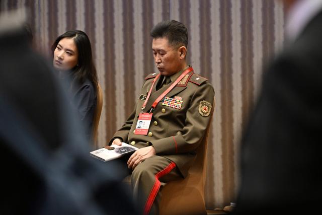 A North Korean military delegate attends a panel discussion on Asia-Pacific Security Cooperation at the Xiangshan Forum at the Beijing International Convention Center in Beijing on September 18, 2025. (Photo by GREG BAKER / AFP)