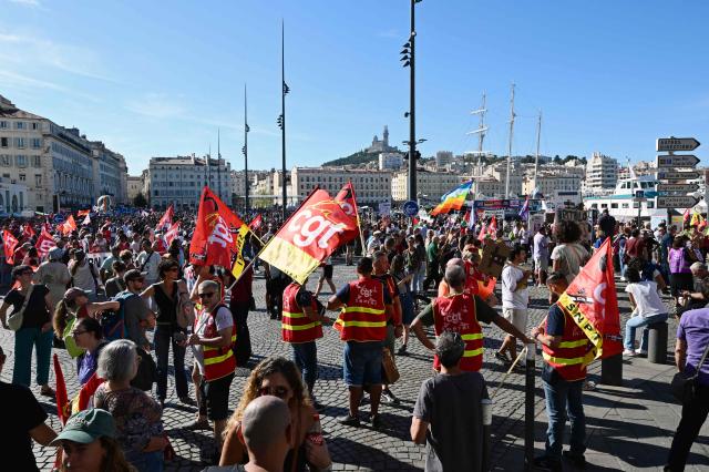Protesters hold flags of the General Confederation of Labour (CGT) union in Marseille, southeastern France, on September 18, 2025, during a day of nationwide strikes and protests called by unions over France's national budget. France is bracing for a day of nationwide protests on September 18, 2025, with a source close to the authorities saying some 800,000 people are expected to take to the streets. In a rare show of unity, trade unions have urged French people to strike in protest at the authorities' "horror show" draft budget designed to reduce France's ballooning debt. (Photo by Miguel MEDINA / AFP)