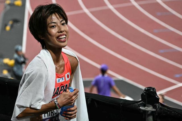Japan's athlete Ririka Hironaka reacts after competing in the women's 5000m heats during the World Athletics Championships in Tokyo on September 18, 2025. (Photo by Philip FONG / AFP)