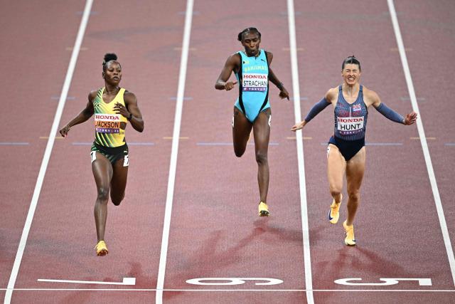 Jamaica's athlete Shericka Jackson (L), Bahamas' athlete Anthonique Strachan and Britain's athlete Amy Hunt run to the finish line as they compete in the women's 200m semi-final during the World Athletics Championships in Tokyo on September 18, 2025. (Photo by Philip FONG / AFP)