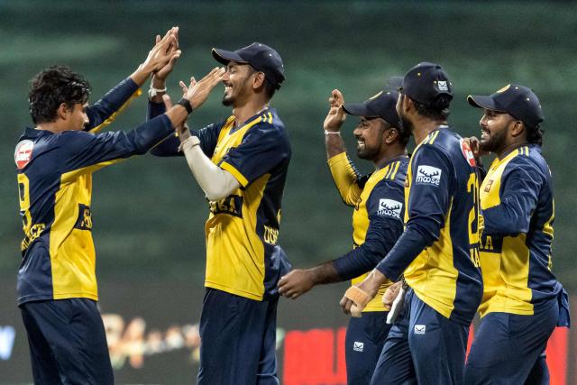 Sri Lanka's Dunith Wellalage (L) celebrates with teammates after taking the wicket of Afghanistan's Ibrahim Zadran during the Asia Cup 2025 Twenty20 international cricket match between Afghanistan and Sri Lanka at the Sheikh Zayed Cricket Stadium in Abu Dhabi on September 18, 2025. (Photo by Fadel SENNA / AFP)