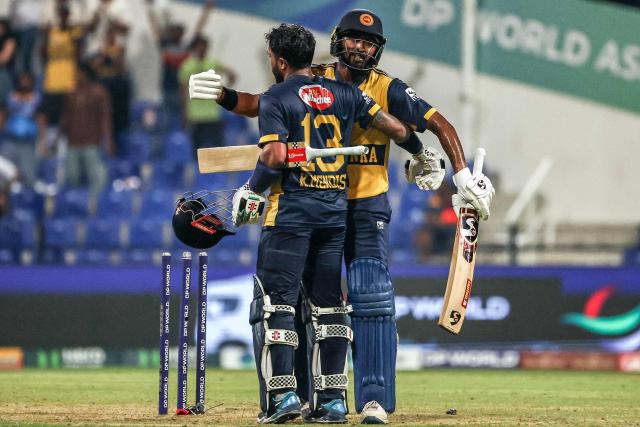 Sri Lanka's Kusal Mendis (front) and Kamindu Mendis celebrate their team's win in the Asia Cup 2025 Twenty20 international cricket match between Afghanistan and Sri Lanka at the Sheikh Zayed Cricket Stadium in Abu Dhabi on September 18, 2025. (Photo by Fadel SENNA / AFP)