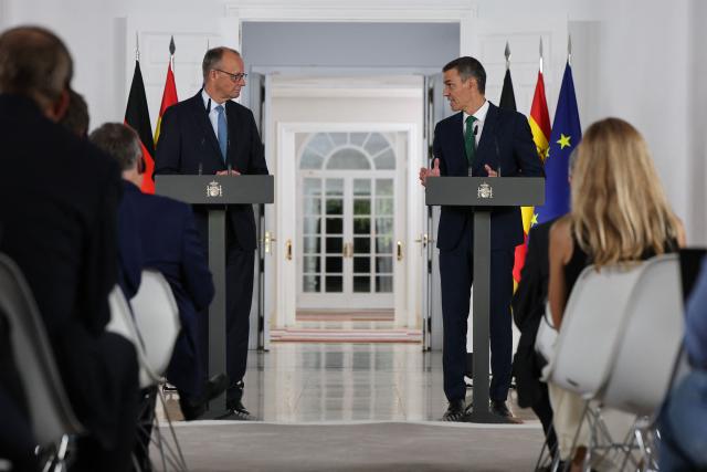 Spain's Prime Minister Pedro Sanchez (R) speaks next to German Chancellor Friedrich Merz during a joint press conference at the Moncloa Palace in Madrid on September 18, 2025. (Photo by Thomas COEX / AFP)