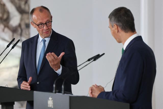 German Chancellor Friedrich Merz (L) attends a joint press conference with Spain's Prime Minister Pedro Sanchez at the Moncloa Palace in Madrid on September 18, 2025. (Photo by Thomas COEX / AFP)