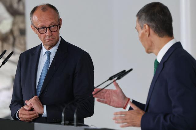 German Chancellor Friedrich Merz (L) attends a joint press conference with Spain's Prime Minister Pedro Sanchez at the Moncloa Palace in Madrid on September 18, 2025. (Photo by Thomas COEX / AFP)