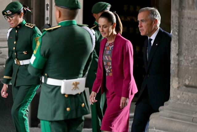 Canada's Prime Minister Mark Carney (R) is welcomed by Mexico's President Claudia Sheinbaum at the National Palace in Mexico City on September 18, 2025. Mexico's President Claudia Sheinbaum and Canada's Prime Minister Mark Carney met in Mexico City as Trump pushes to renegotiate the USMCA North American trade pact in place since 2020. It replaced the NAFTA accord signed in the 1990s. (Photo by YURI CORTEZ / AFP)