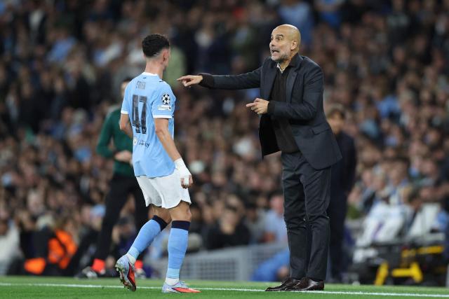 Manchester City's Spanish manager Pep Guardiola gives instructions past English midfielder #47 Phil Foden during the UEFA Champions League league stage football match between Manchester City and Napoli at the Etihad Stadium in Manchester, north west England, on September 18, 2025. (Photo by Darren Staples / AFP)