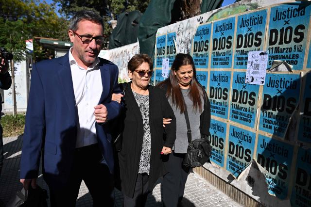 (FILES) Ana Estela (C) and Claudia Maradona, sisters of late Argentine football legend Diego Maradona, arrives at the San Isidro court to attend a trial hearing for the death of their brother in San Isidro, Buenos Aires province on April 3, 2025. Argentine courts on September 18, 2025, seized assets belonging to two of Diego Maradona's sisters, his lawyer, and three other individuals for alleged fraudulent management of the soccer star's brand, who died in 2020, according to a ruling accessed by AFP. (Photo by Luis ROBAYO / AFP)