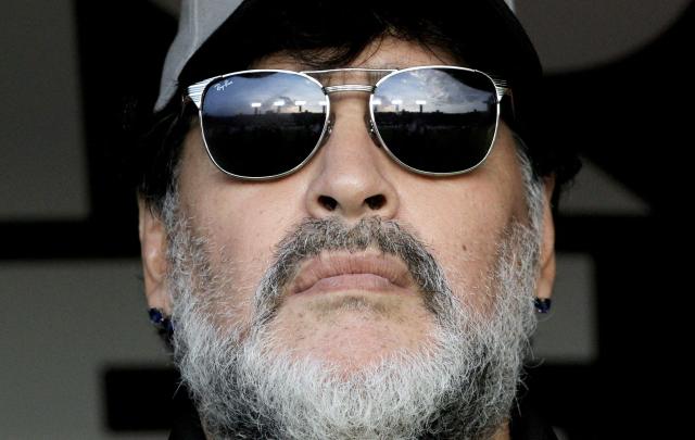 (FILES) The coach of Mexican second division football team Dorados, Argentine Diego Armando Maradona, waits for the start of the second leg match of the Mexican second-division finals against Atletico San Luis, at the Alfonso Lastras Ramirez stadium in San Luis Potosi, Mexico, on May 5, 2019. Argentine courts on September 18, 2025, seized assets belonging to two of Diego Maradona's sisters, his lawyer, and three other individuals for alleged fraudulent management of the soccer star's brand, who died in 2020, according to a ruling accessed by AFP. (Photo by Ulises Ruiz / AFP)