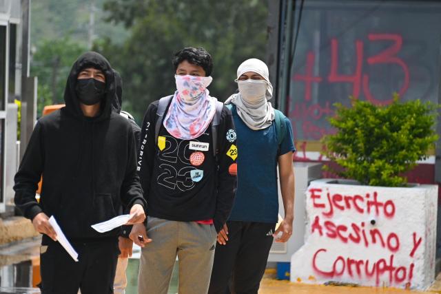People take part in a protest over the 11th anniversary of the disappearance of 43 students from Ayotzinapa, on a toll road at the outskirts of Chilpancingo, Guerrero state, Mexico, on September 18, 2025. The case of the 43 students who disappeared from a rural school in Ayotzinapa in 2014 is one of the most serious human rights violations committed in Mexico, probably involving police officers, drug traffickers and military commanders, according to investigations. (Photo by Francisco ROBLES / AFP)