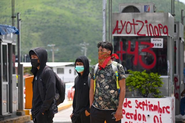 People take part in a protest over the 11th anniversary of the disappearance of 43 students from Ayotzinapa, at a toll road at the outskirts of Chilpancingo, Guerrero state, Mexico, on September 18, 2025. The case of the 43 students who disappeared from a rural school in Ayotzinapa in 2014 is one of the most serious human rights violations committed in Mexico, probably involving police officers, drug traffickers and military commanders, according to investigations. (Photo by Francisco ROBLES / AFP)
