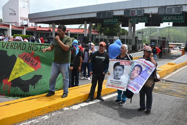 Relatives take part in a protest over the 11th anniversary of the disappearance of 43 students from Ayotzinapa, on a toll road at the outskirts of Chilpancingo, Guerrero state, Mexico, on September 18, 2025. The case of the 43 students who disappeared from a rural school in Ayotzinapa in 2014 is one of the most serious human rights violations committed in Mexico, probably involving police officers, drug traffickers and military commanders, according to investigations. (Photo by Francisco ROBLES / AFP)