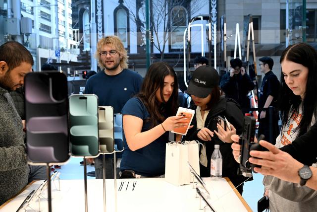 Customers explore the features of the newly launched iPhone 17 Pro at an Apple Store in Sydney on September 19, 2025. (Photo by Saeed KHAN / AFP)