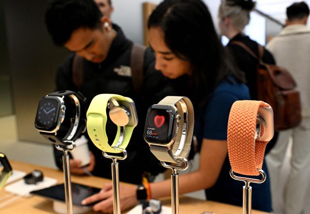 Customers explore the features of the newly launched Apple watches at an Apple Store in Sydney on September 19, 2025. (Photo by Saeed KHAN / AFP)