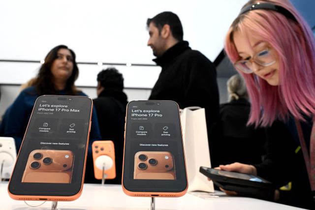 Customers explore the features of the newly launched iPhone 17 Pro at an Apple Store in Sydney on September 19, 2025. (Photo by Saeed KHAN / AFP)