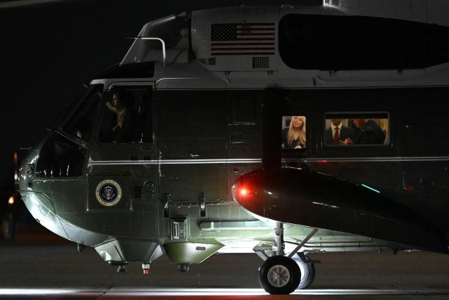 US President Donald Trump (R) and his daughter Tiffany Trump (L) are seen through the windows of Marine One at Joint Base Andrews in Maryland on September 18, 2025, as they return to Washington from their trip to the United Kingdom. (Photo by ANDREW CABALLERO-REYNOLDS / AFP)