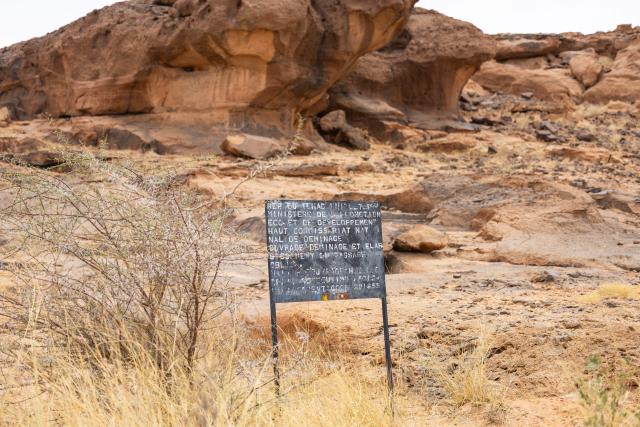 A general view of a sign indicating a cleared area in Wadi Inou, on the road between Fada and Garoa Hallagana, in Ennedi Ouest Province, Chad, on July 10, 2025. A five-day scientific mission, conducted at the end of July, thirty kilometers from Fada, brought together Chadian archaeologists and geologists from the universities of N'Djamena and Abeche.
The objective: to lay "the first milestone" in the chronological markers of the ancient occupation of the Ennedi region, the researcher asserts.
The Ennedi Natural and Cultural Reserve (RNCE), created in 2018 in this Chadian province, at the crossroads with Libya and Sudan, is home to a rich archaeological heritage.
Across a sanctuary spanning more than 50,000 square kilometers, tens of thousands of rock engravings and paintings adorn the rock faces.
Following the inscription of the RNCE on the World Heritage List in 2016, the Chadian government entrusted its co-management to the South African NGO African Parks for fifteen years. (Photo by Joris Bolomey / AFP)