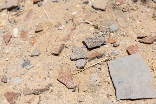 Ceramic fragments lay on the ground at the Garoa Hallagana rock art site, in Ennedi Ouest province, Chad, on July 10, 2025. A five-day scientific mission, conducted at the end of July, thirty kilometers from Fada, brought together Chadian archaeologists and geologists from the universities of N'Djamena and Abeche.
The objective: to lay "the first milestone" in the chronological markers of the ancient occupation of the Ennedi region, the researcher asserts.
The Ennedi Natural and Cultural Reserve (RNCE), created in 2018 in this Chadian province, at the crossroads with Libya and Sudan, is home to a rich archaeological heritage.
Across a sanctuary spanning more than 50,000 square kilometers, tens of thousands of rock engravings and paintings adorn the rock faces.
Following the inscription of the RNCE on the World Heritage List in 2016, the Chadian government entrusted its co-management to the South African NGO African Parks for fifteen years. (Photo by Joris Bolomey / AFP)